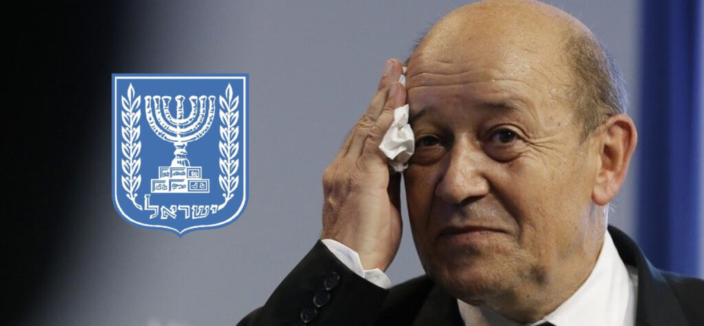 France's Defence Minister Jean-Yves Le Drian wipes his face as he attends a news conference in Paris October 3, 2013. France's military will cut about 7,800 jobs next year, Defence Minister Jean-Yves Le Drian said on Thursday, detailing government belt-tightening plans that the far-right hopes will deliver it votes at municipal elections in 2014.   REUTERS/Gonzalo Fuentes (FRANCE - Tags: POLITICS MILITARY) - RTR3FK4S